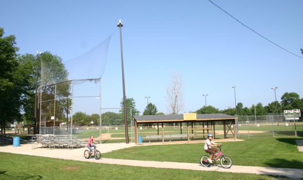 a - park - baseball field wi children on bikes